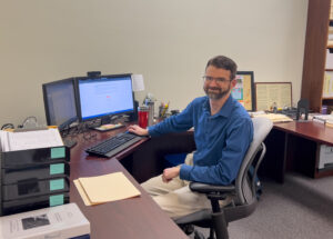 Librarian Derek Rieckens at his desk